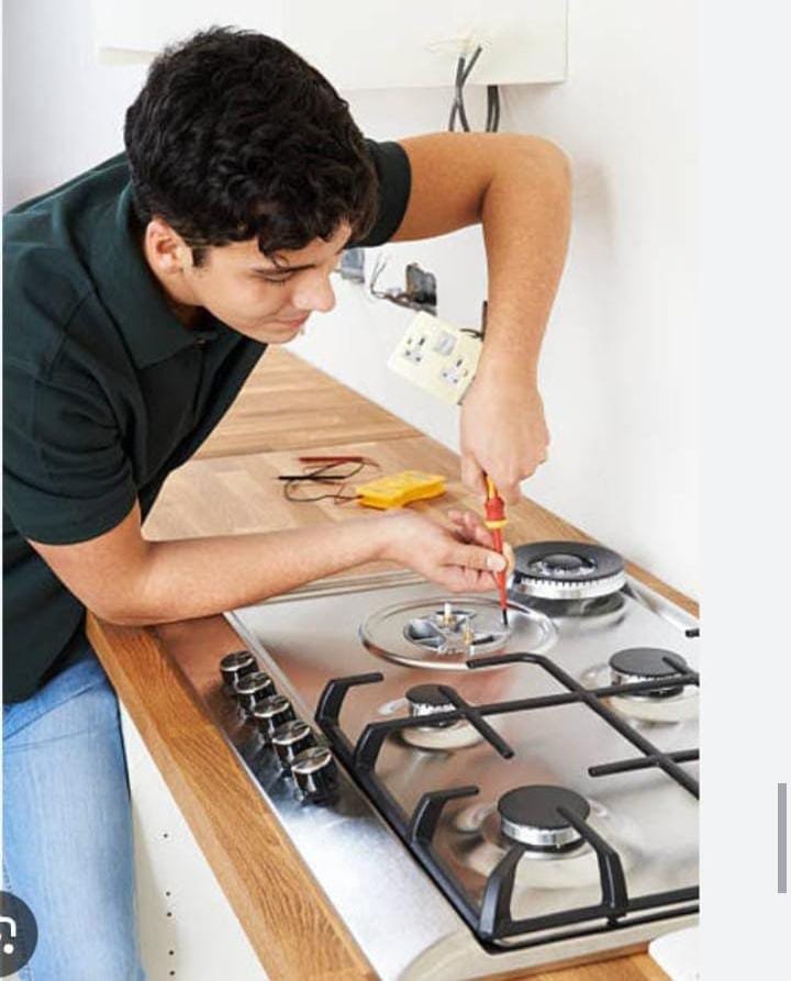 Technician repairing a gas stove